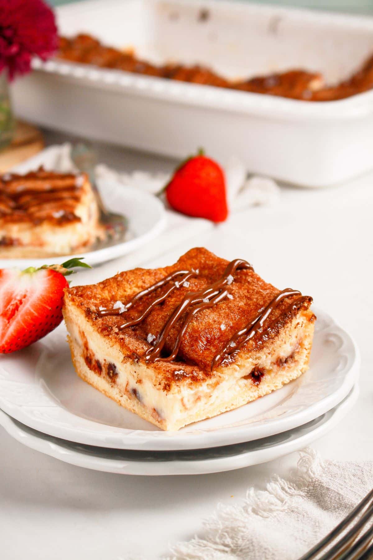 Slice of cheesecake crescent roll on a plate.