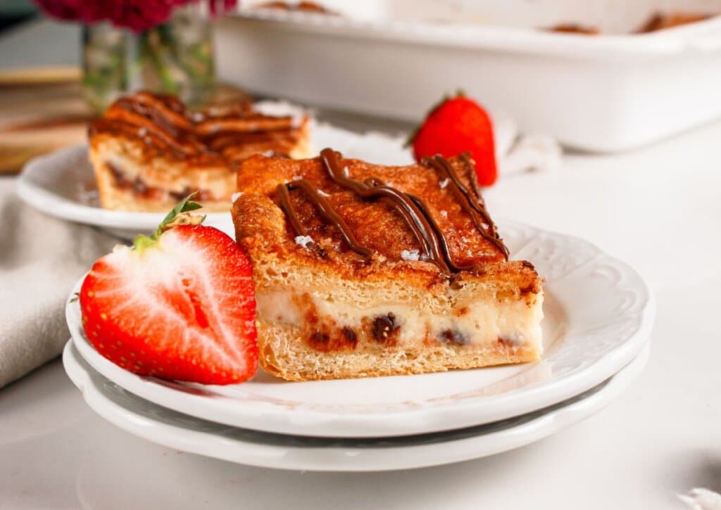Slice of cheesecake crescent roll on a plate.