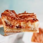Slice of cheesecake crescent roll on a spatula.