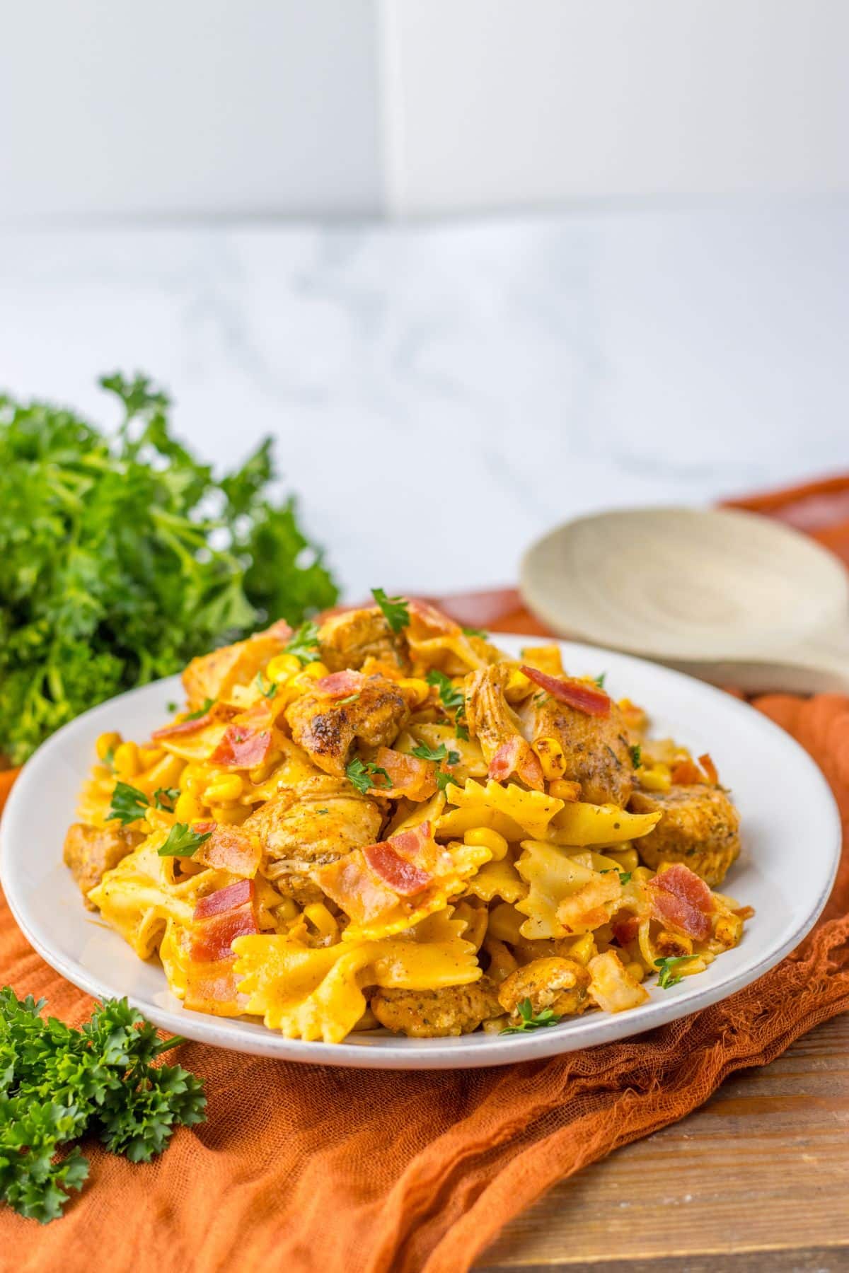 Plate full of chicken and corn pasta.