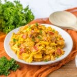 Plate full of chicken and corn pasta.