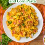 Plate full of chicken and corn pasta.