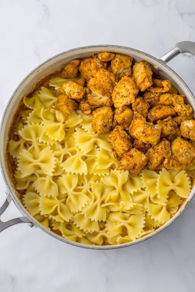Chicken and pasta in a skillet.