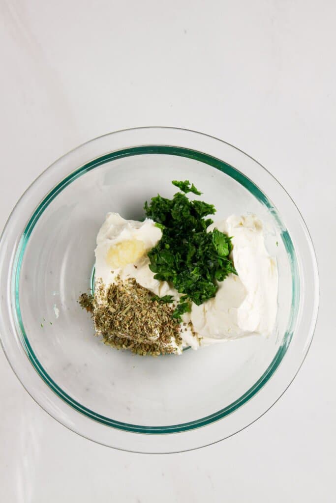 Filling ingredients being mixed together in a glass bowl.
