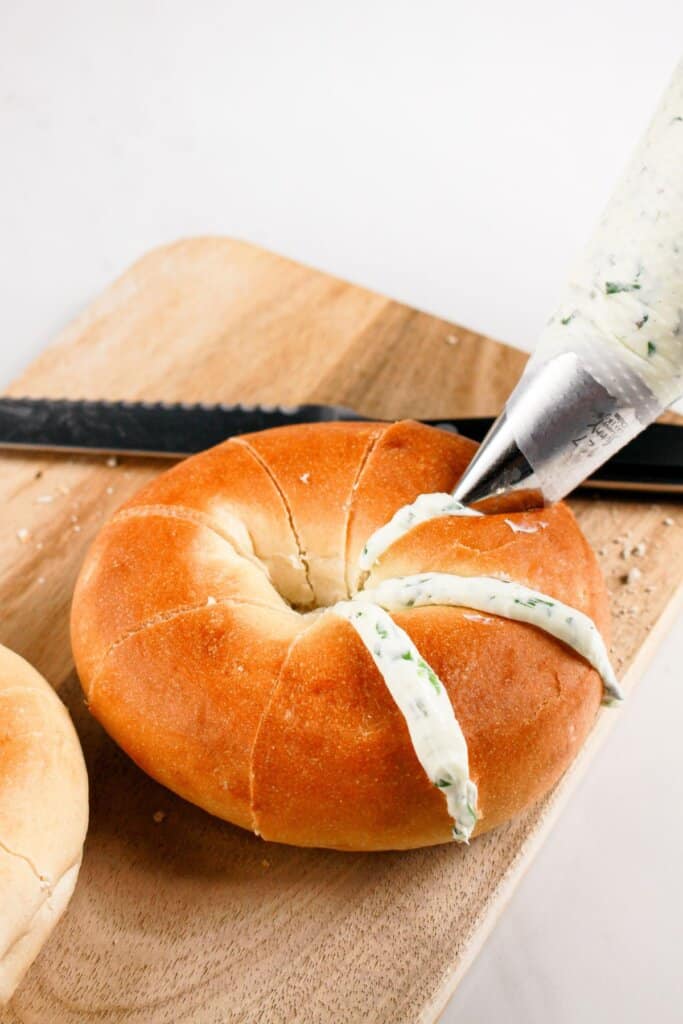 Filling being piped into bread.