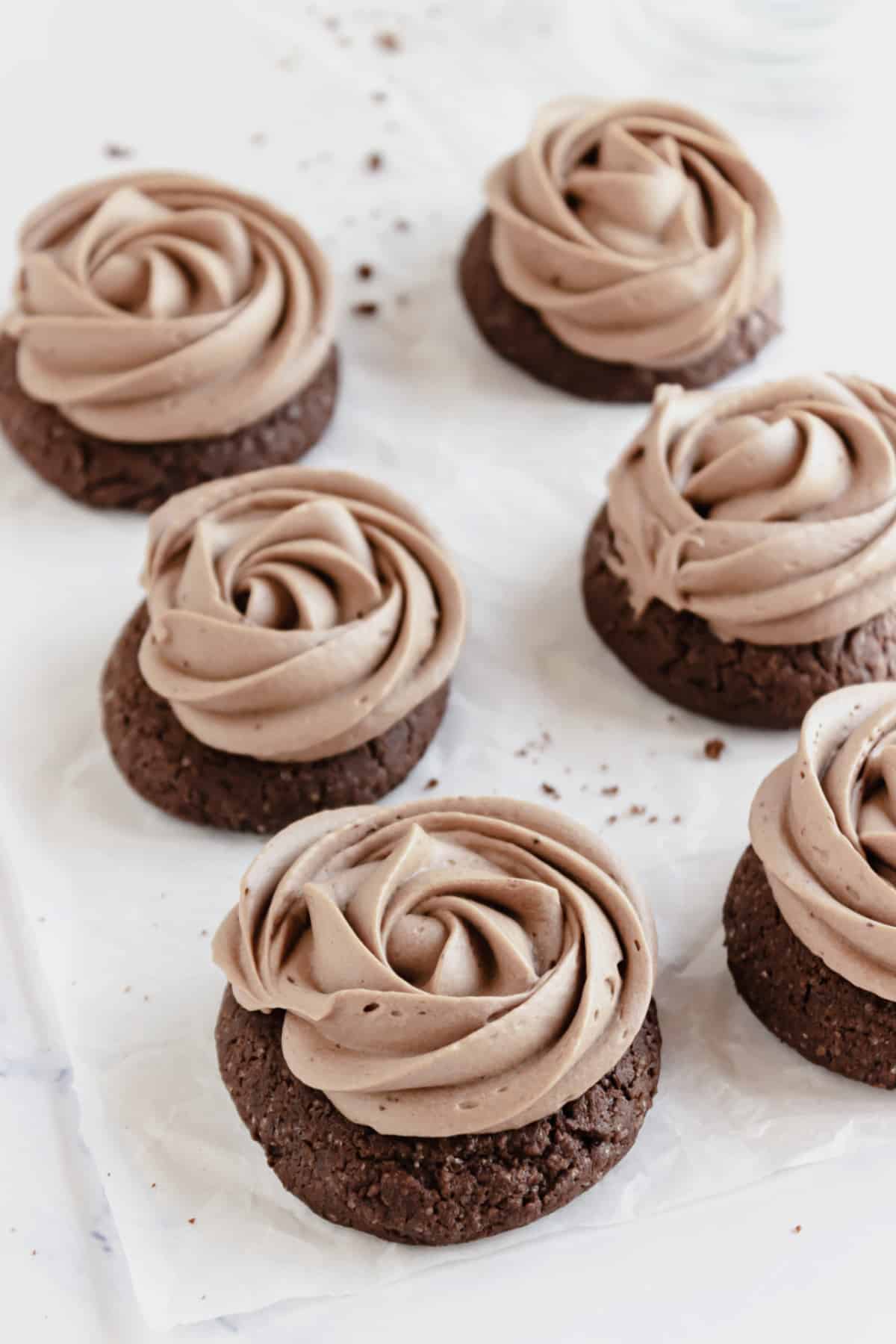 Frosted cookies on parchment paper.