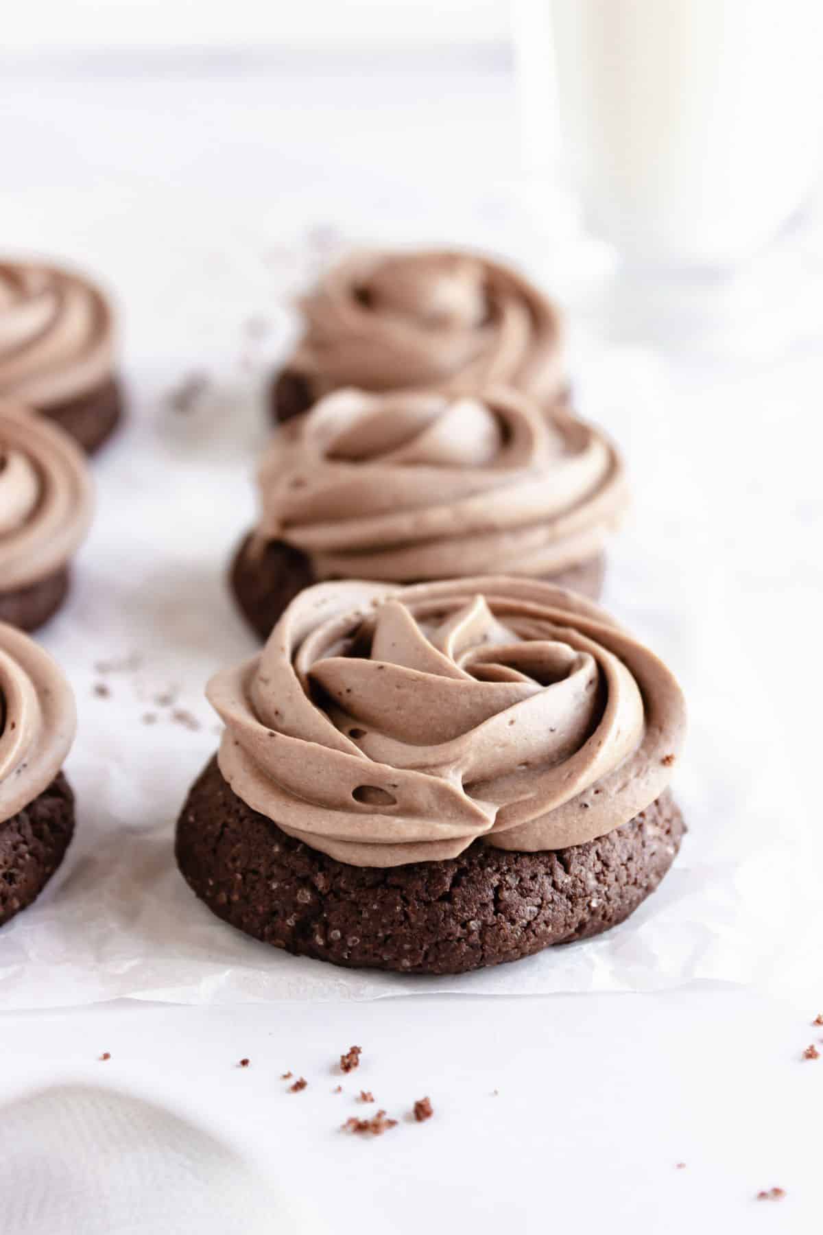 Frosted cookies on parchment paper.