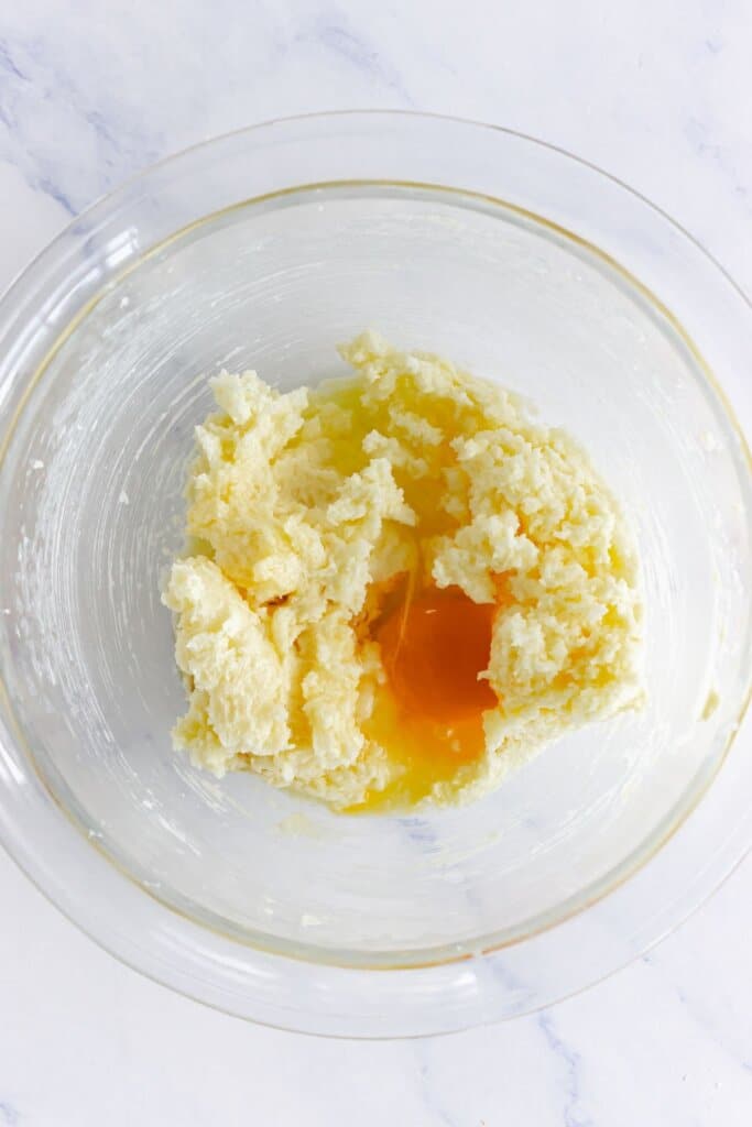 Butter, egg, and vanilla in a glass mixing bowl.