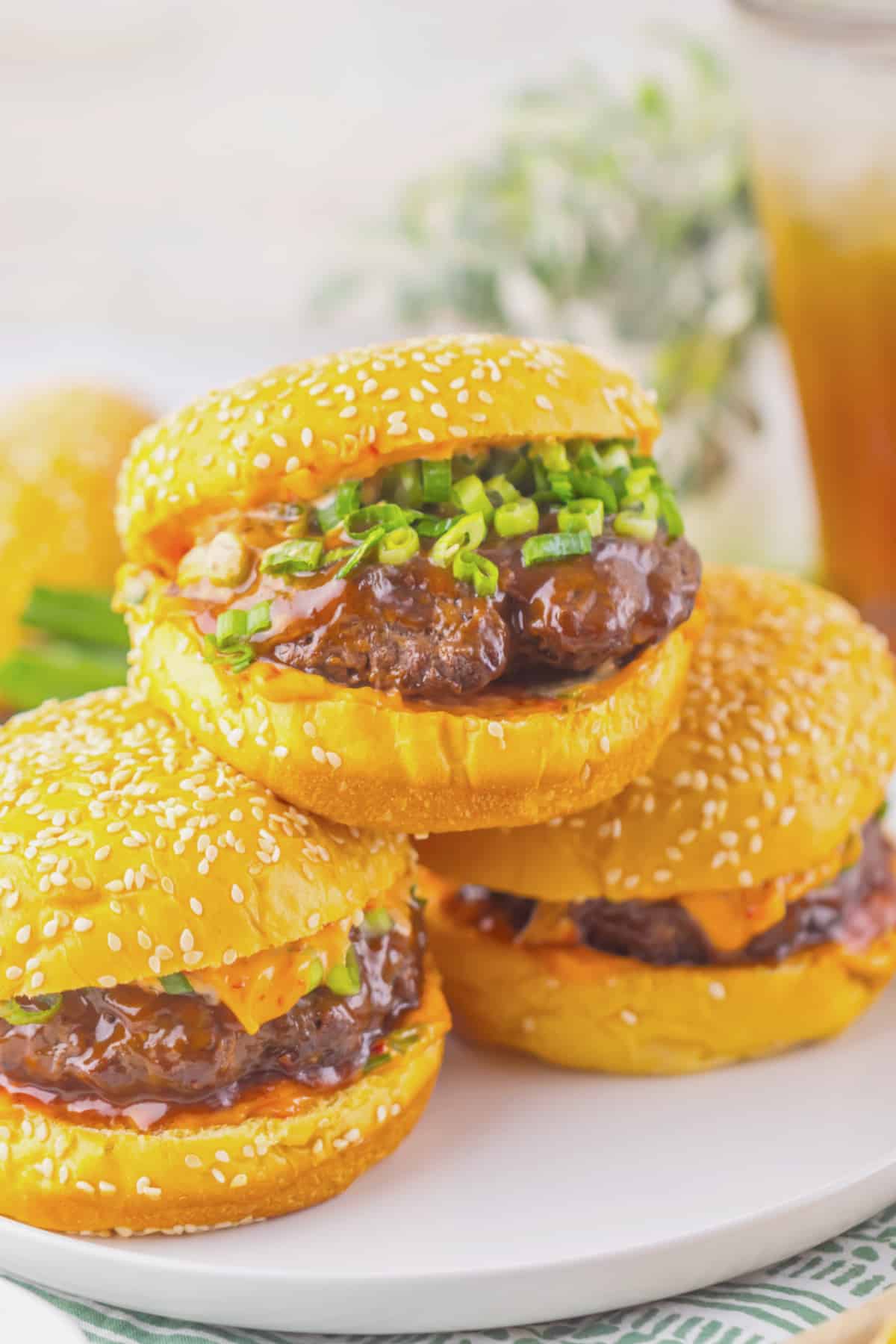 Three korean burgers on a plate.
