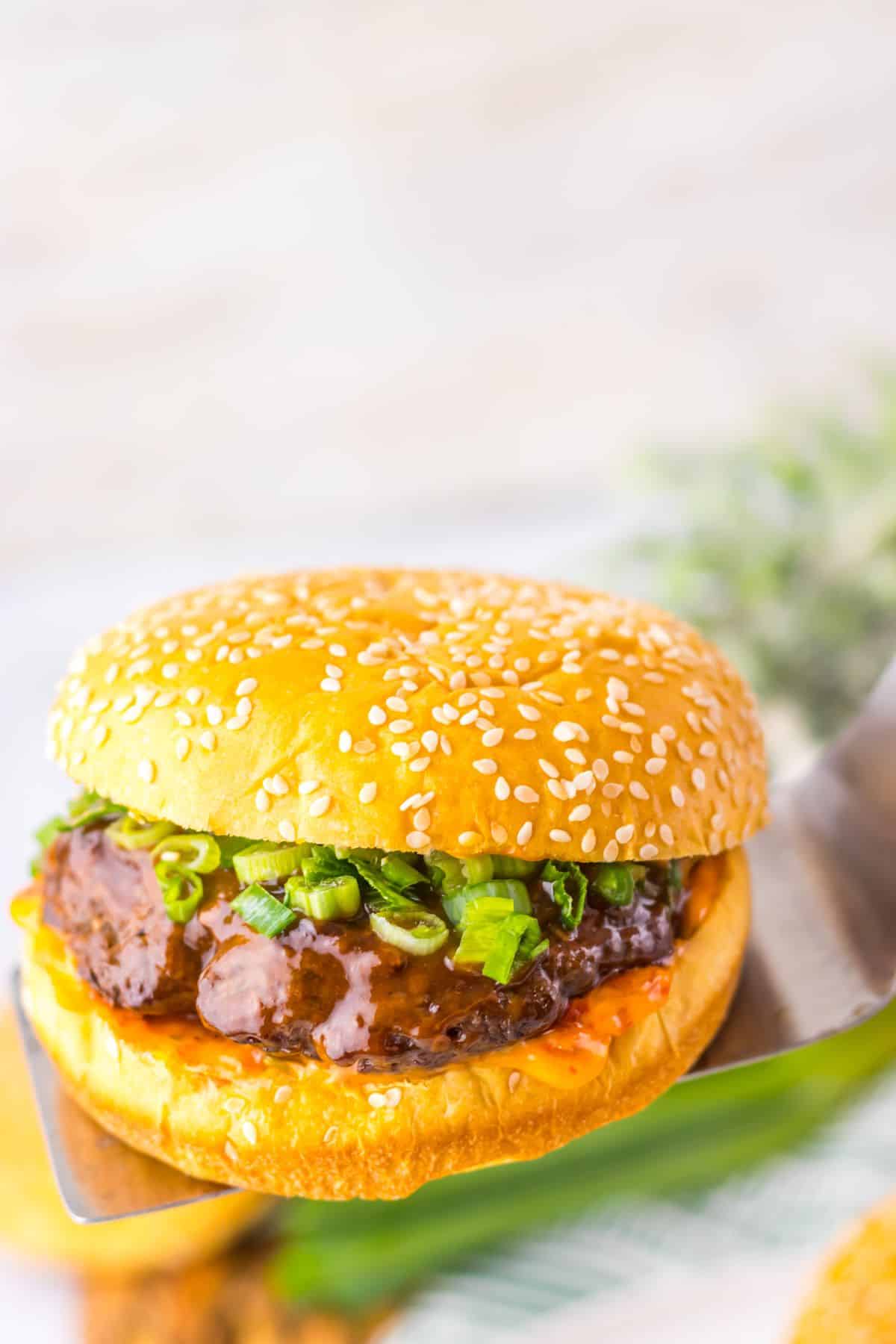 Korean burgers on a metal spatula.
