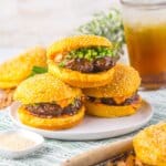 Three korean burgers on a plate.