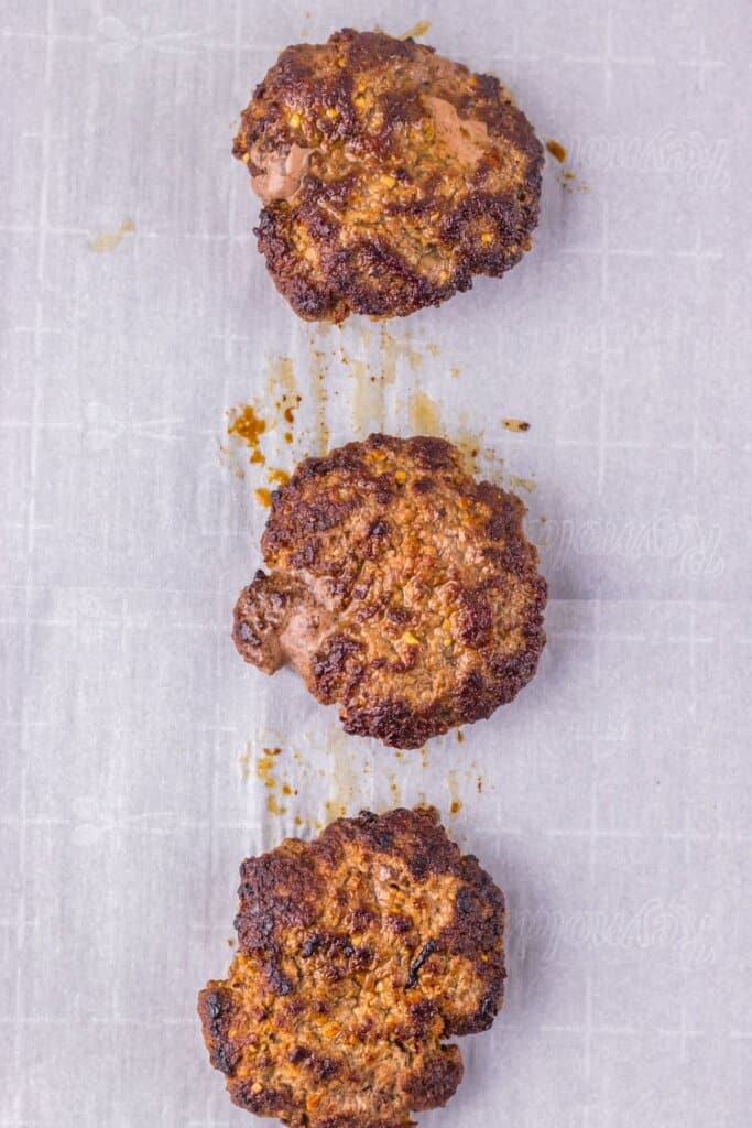 Patties on a parchment lined baking sheet.