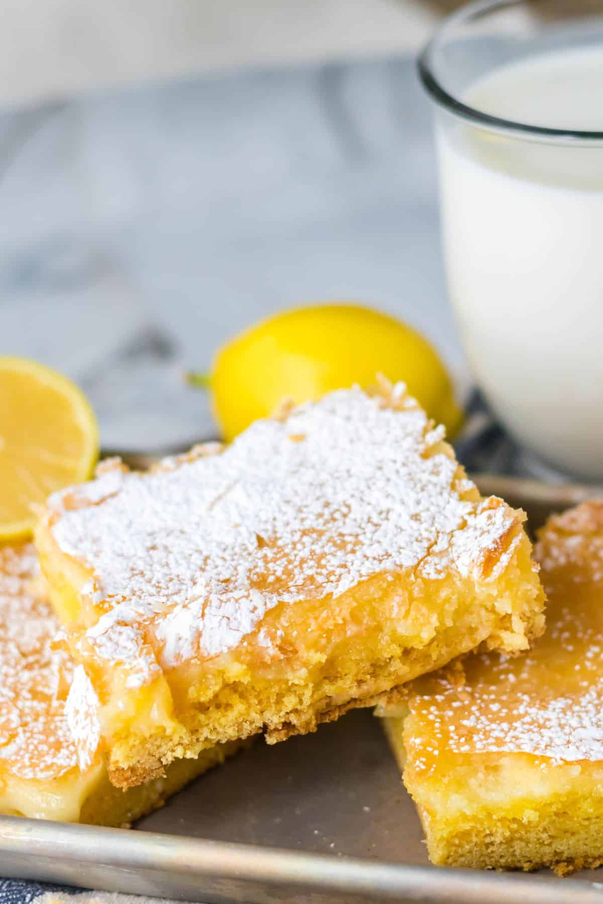 Three slices of gooey butter cake on a metal tray.