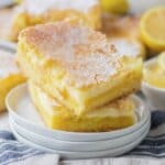 Two slices of lemon gooey butter cake on a plate.