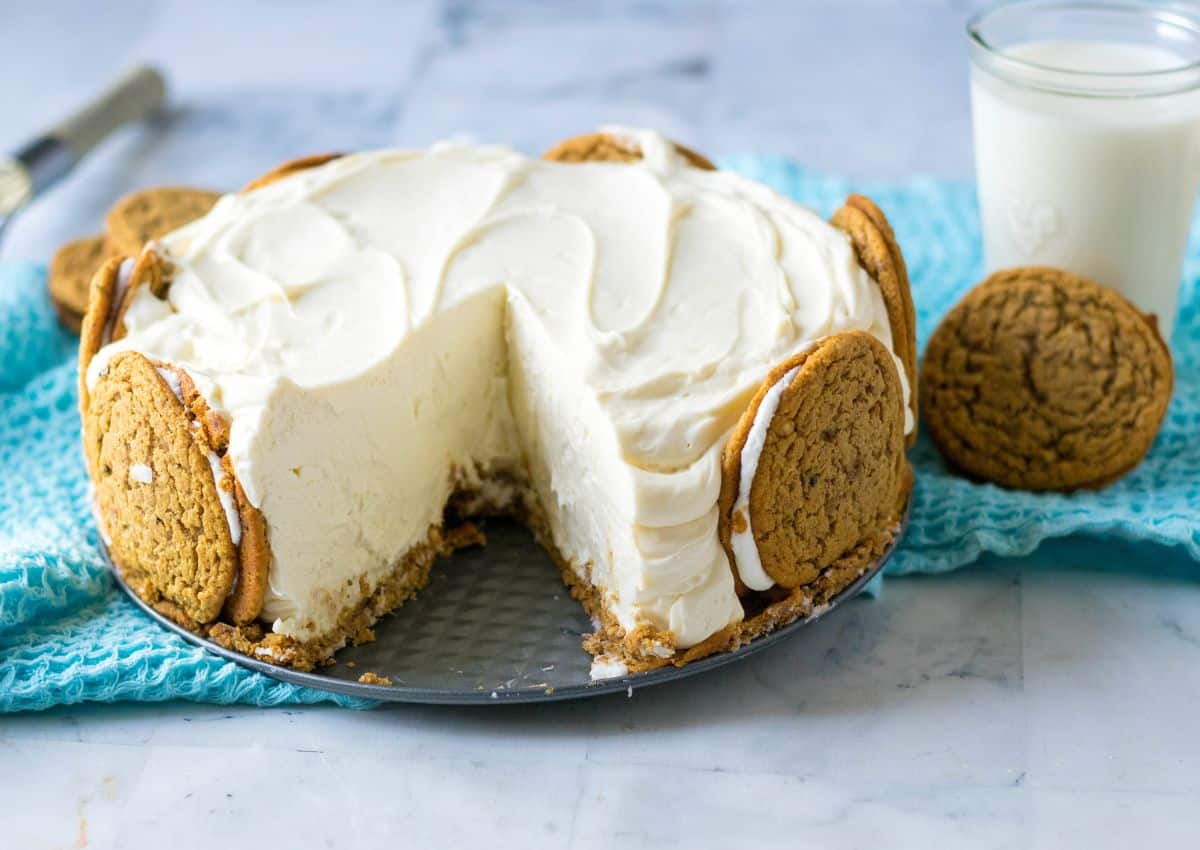 Cheesecake on a springform pan bottom with a slice missing.
