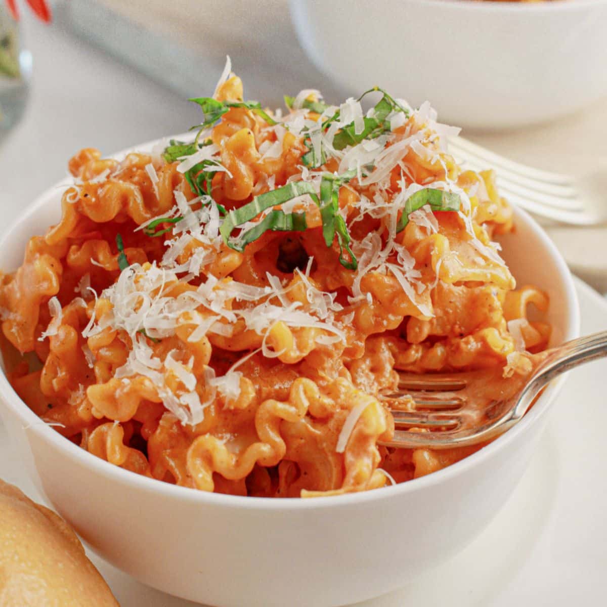 White bowl full of pasta alla vodka.