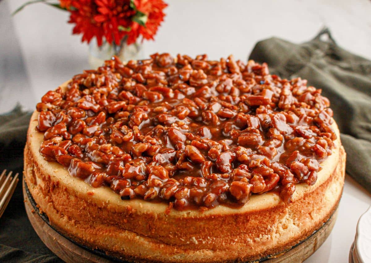 Full pecan pie cheesecake on a serving platter.
