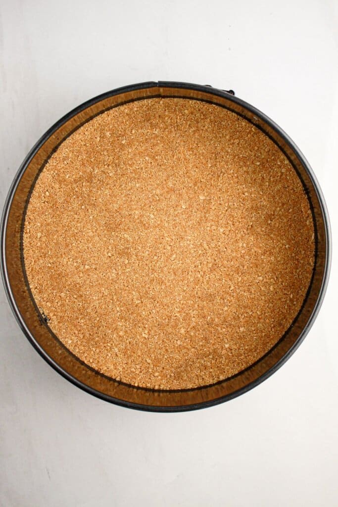 Crust pressed into a springform pan.
