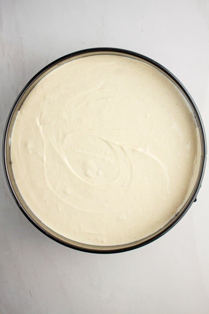 Batter being spread into a springform pan.