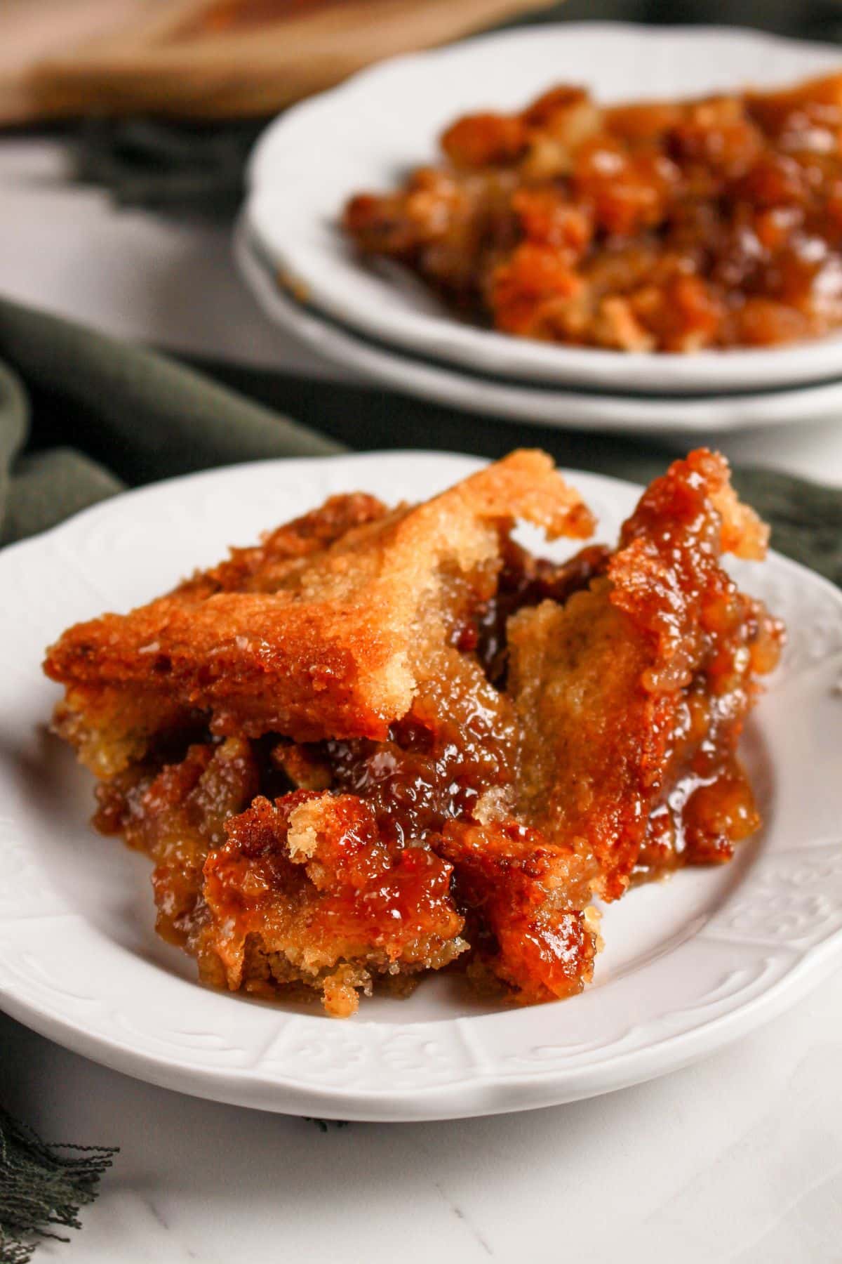 Serving of pecan pie cobbler on a plate.