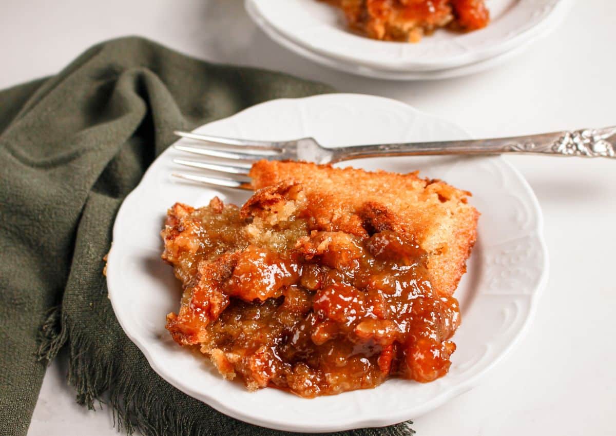 Serving of pecan pie cobbler on a plate.