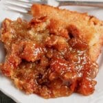 Serving of pecan pie cobbler on a plate.
