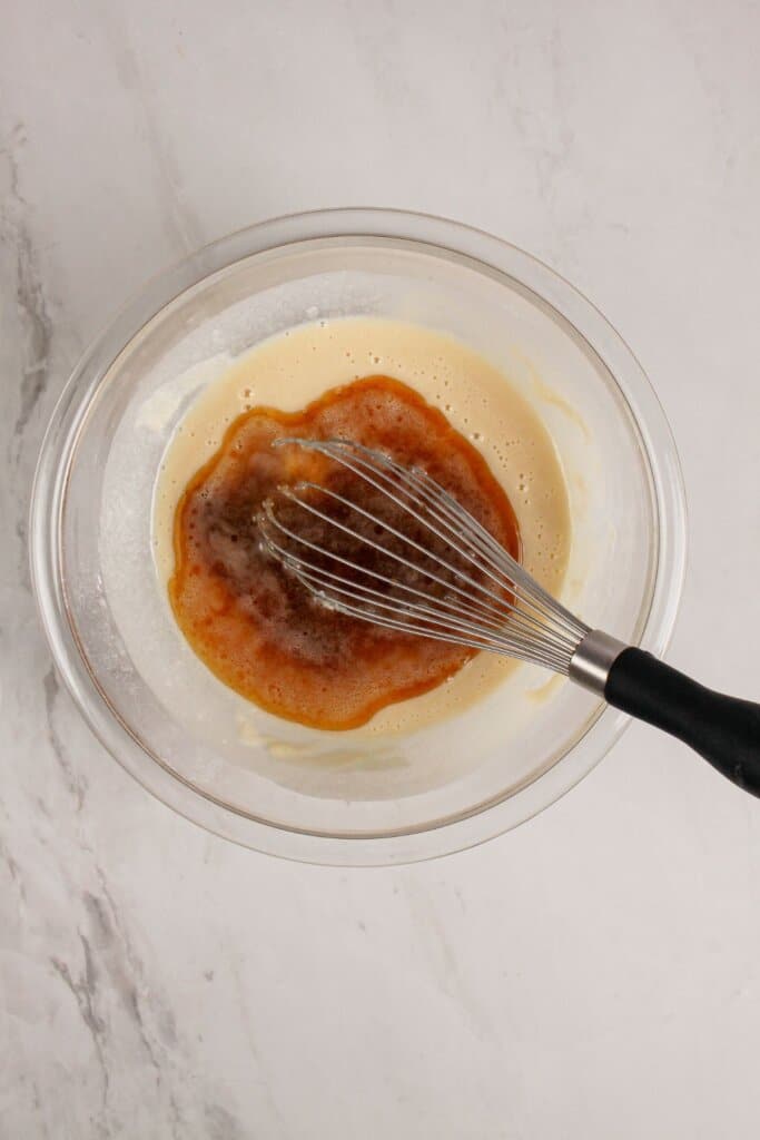 Topping being mixed in a glass bowl.
