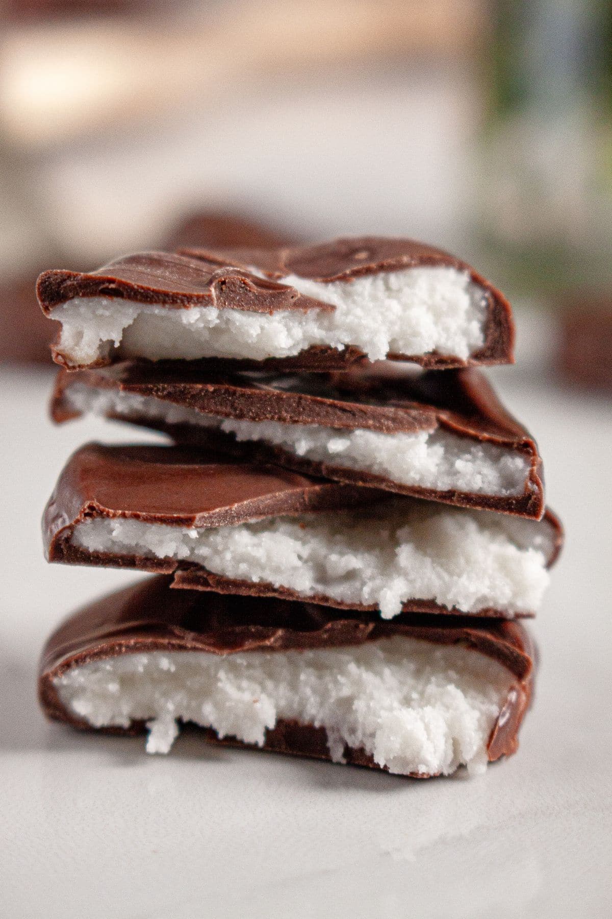 Peppermint patties stacked on a counter to show the inside.