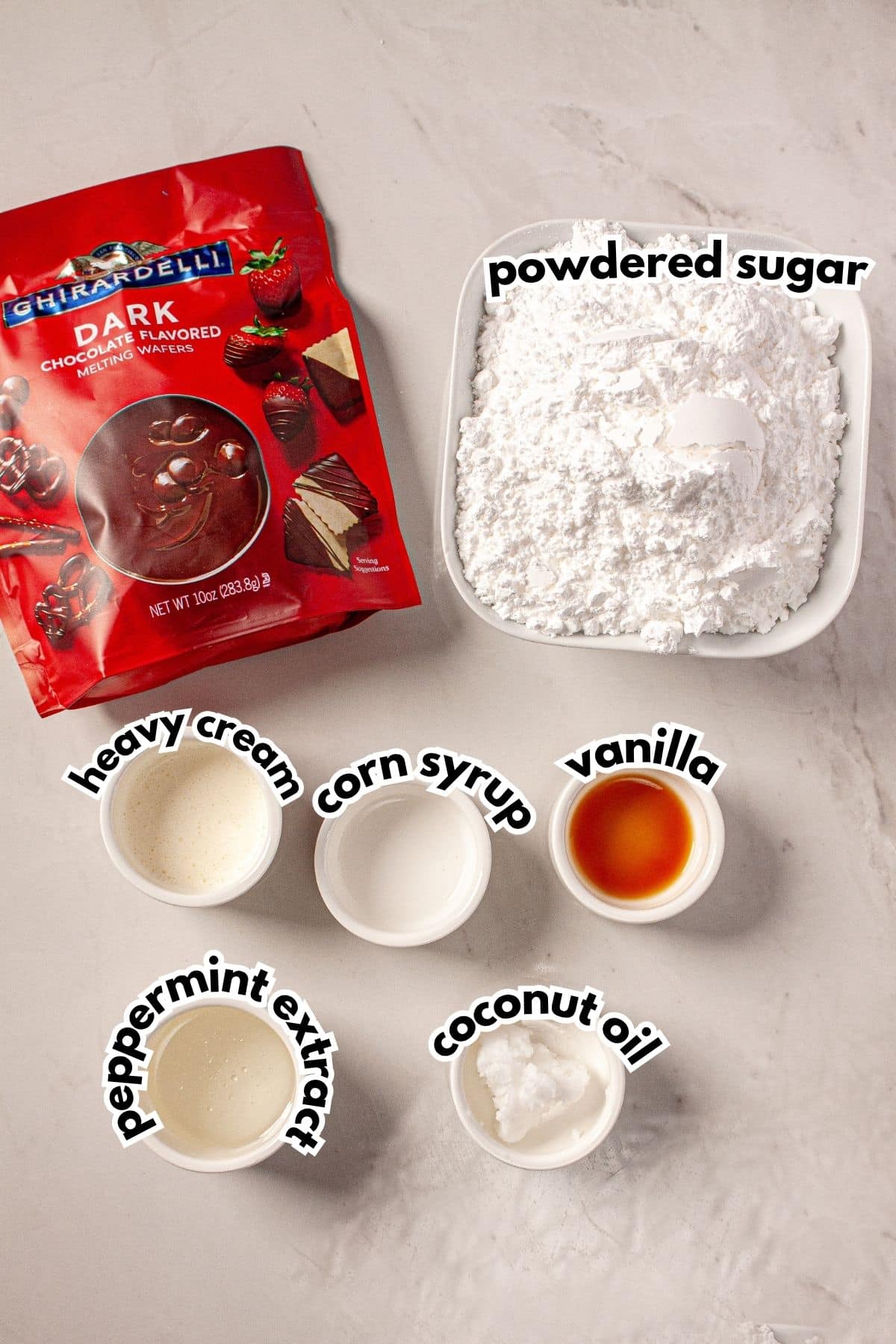 Bowls of ingredients labelled with text on a counter.