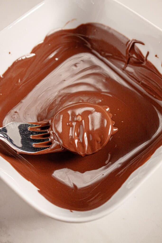 Filling being dipped in chocolate.