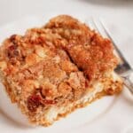 Slice of pumpkin pecan dump cake on a plate.