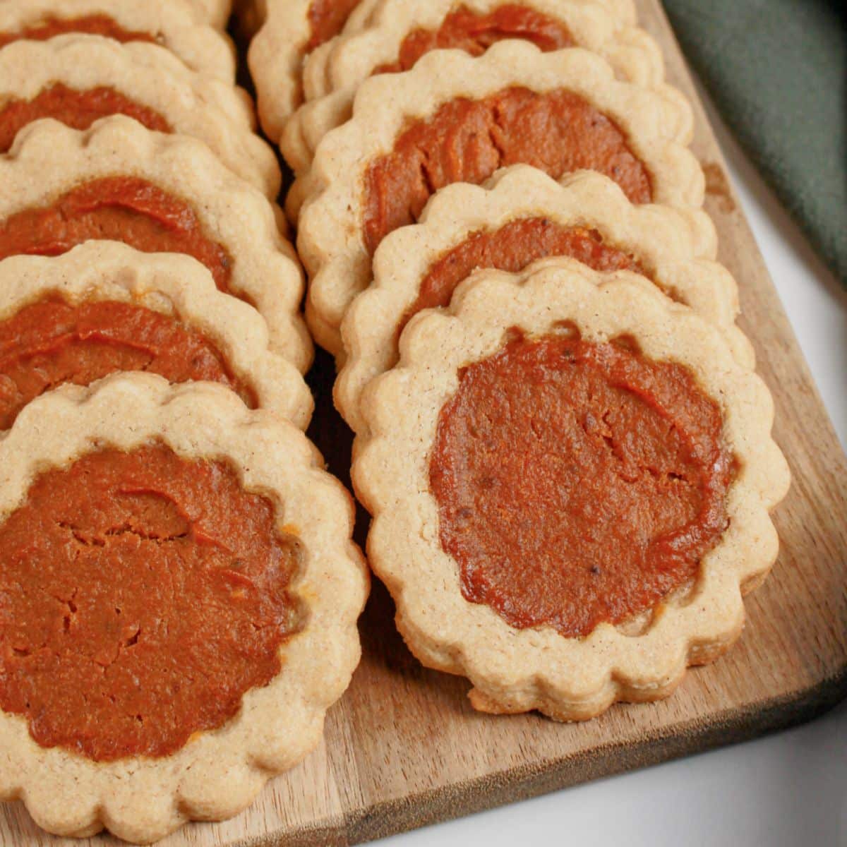 Pumpkin pie cookies on a wooden tray.