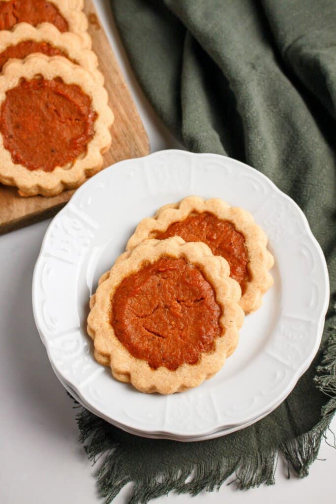 Two pumpkin pie cookies on a plate.