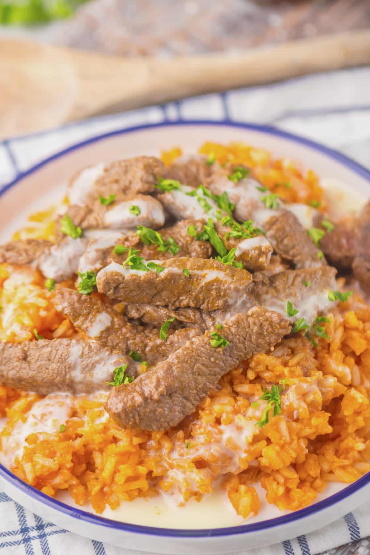 Plate full of queso steak and rice.