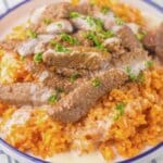 Plate full of queso steak and rice.