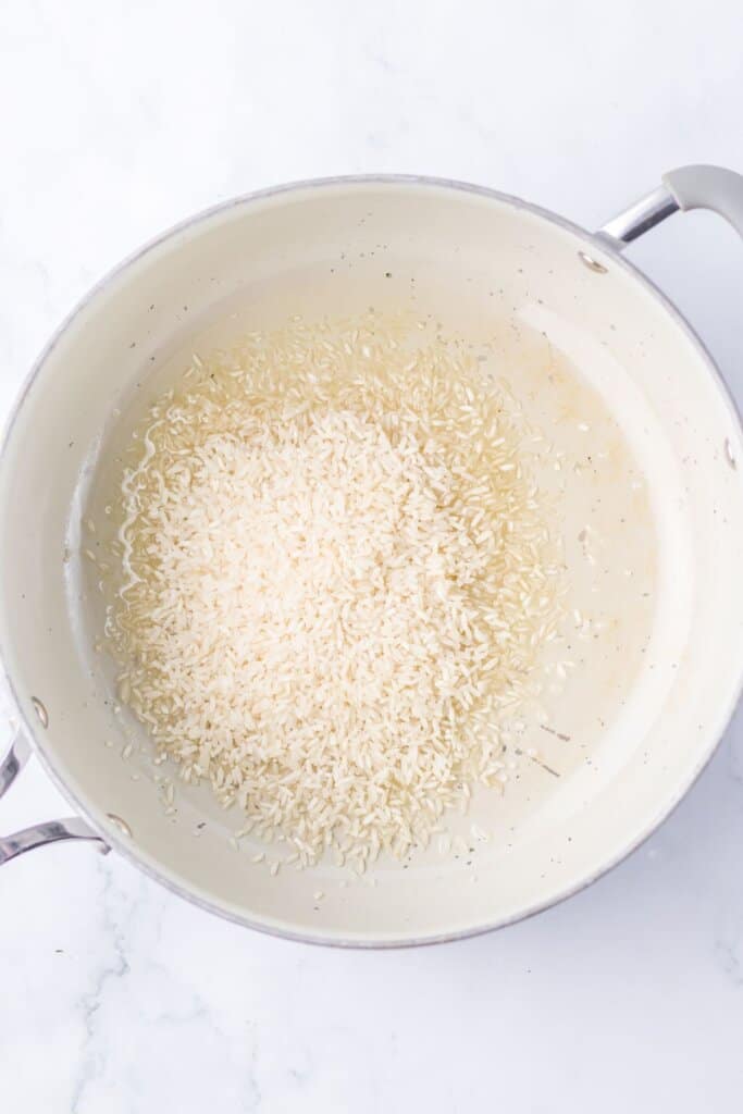 Rice cooking in a skillet.