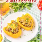Two sloppy joe stuffed peppers on a plate.
