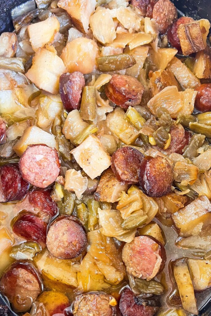 Slow cooker full of kielbasa and vegetables.