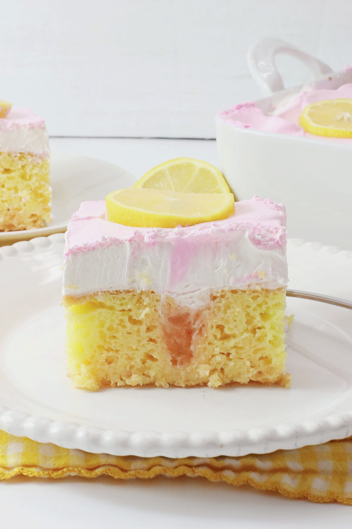 Slice of watermelon poke cake on a plate.