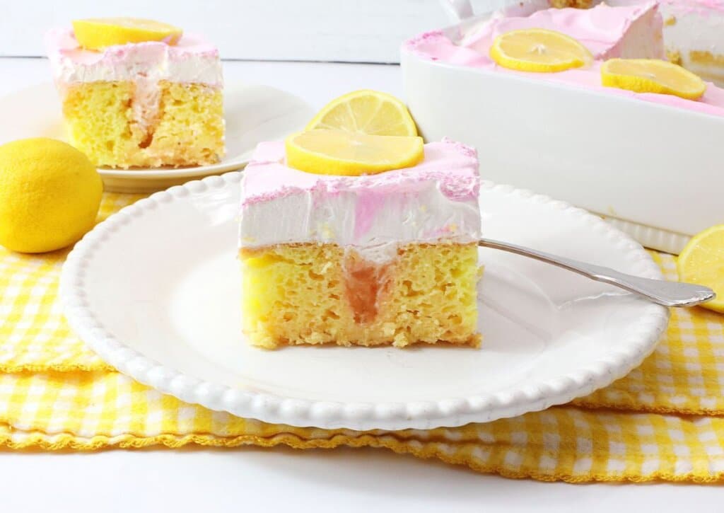 Slice of watermelon poke cake on a plate.