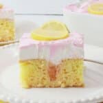 Slice of watermelon poke cake on a plate.