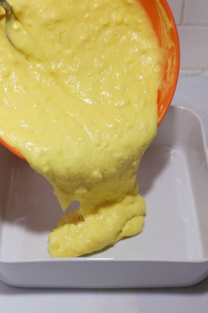 Batter being spread in baking dish.