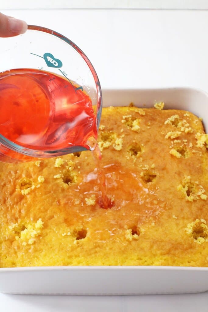 Jello being poured into cake.