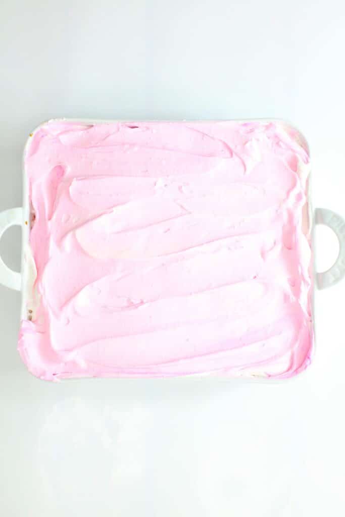 Whipped topping being spread on dessert.