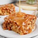Slice of apple pecan cake on a small plate.