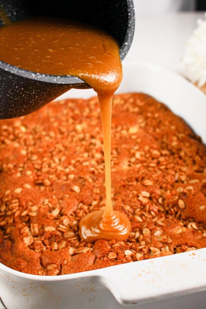 Glaze being poured on top of a dessert.