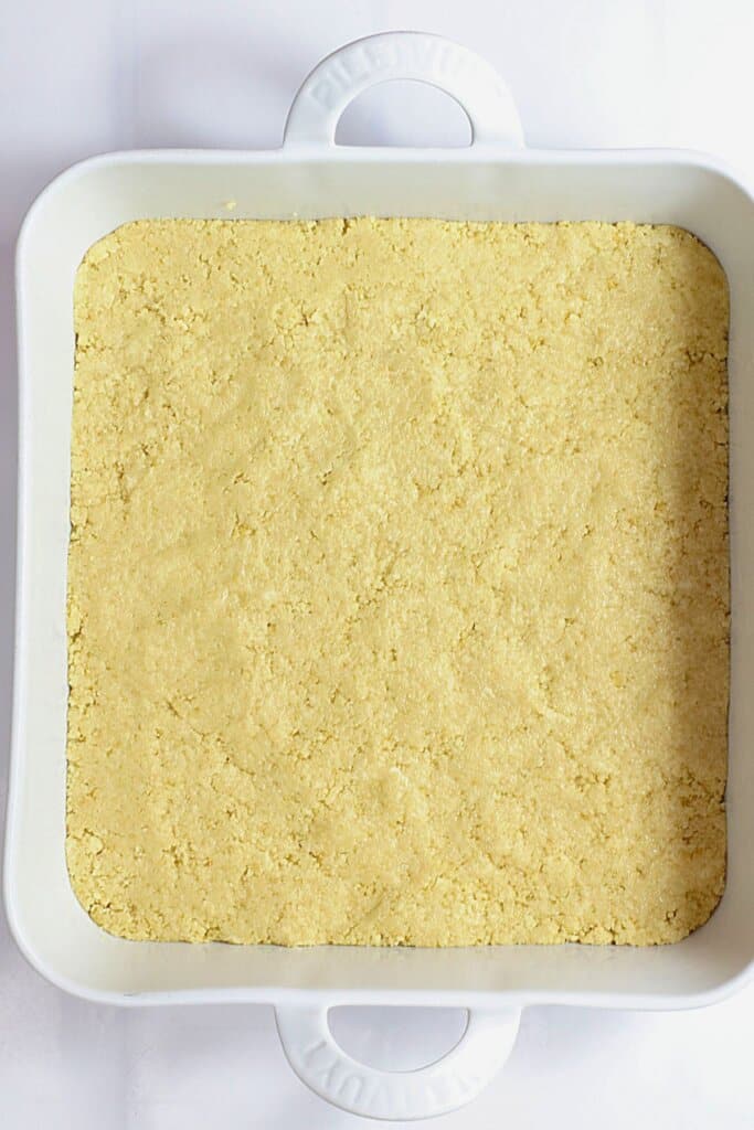 Crust being pressed into a baking dish.