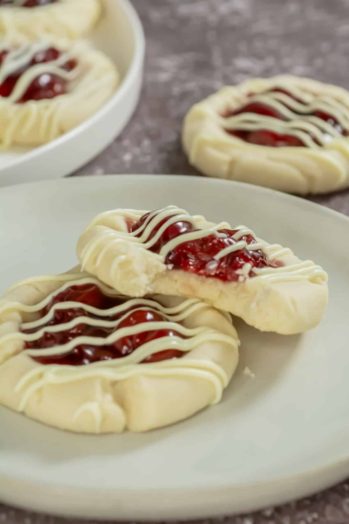 Two cherry pie cookies on a plate.