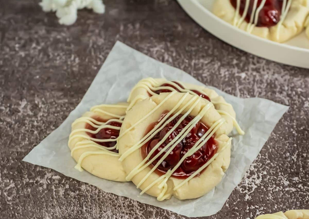 Three cherry pie cookies on a napkin.