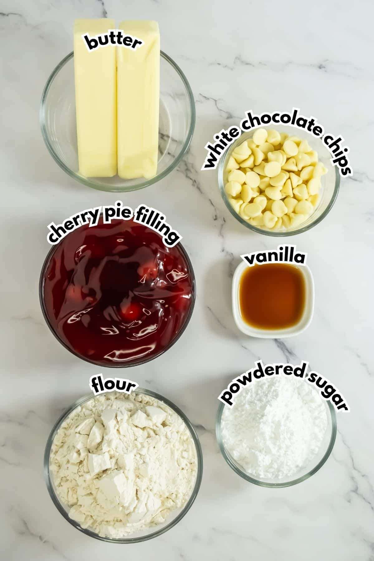 Bowls of ingredients labelled with text on a counter.